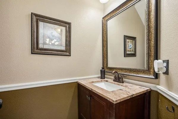 a bathroom with a sink vanity and a mirror