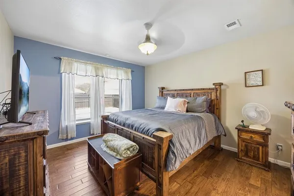 a bedroom with a bed and wooden floor