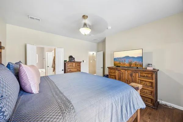 a bedroom with a bed and a tv on table