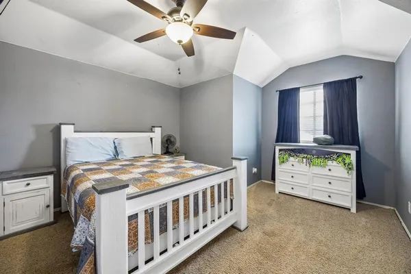 a bedroom with a bed and a baby crib