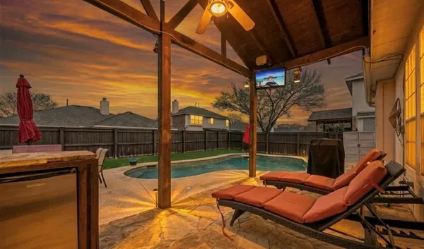 a view of a chairs and table in the patio