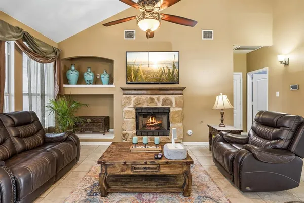 a living room with furniture and a fireplace