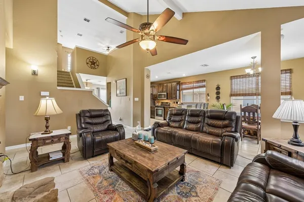 a living room with furniture a rug and a chandelier