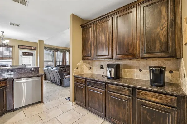 a kitchen with stainless steel appliances granite countertop a stove sink and cabinets