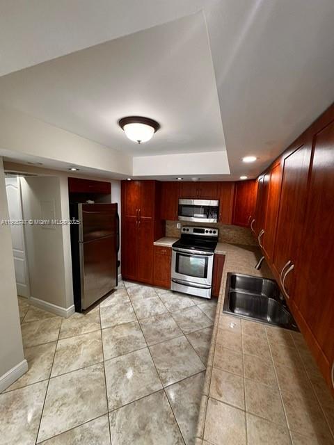 6724 Southwest 114th Place, Unit F Miami, FL 33173 - Photo 12 of 27 a kitchen with refrigerator and stove