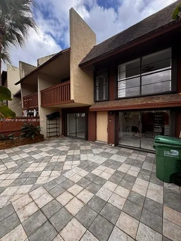 a front view of a house with a parking space