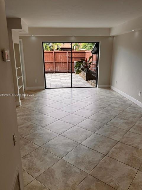 6724 Southwest 114th Place, Unit F Miami, FL 33173 - Photo 7 of 27 a view of empty room with white walls and window