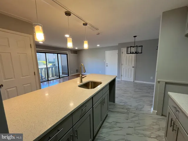 a kitchen with a sink and large window