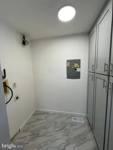 a view of a room with wooden floor and mirror