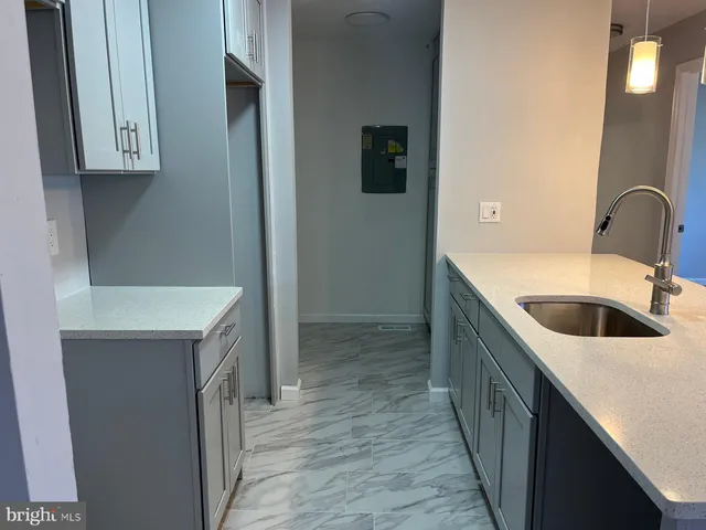 a kitchen with a sink and a refrigerator