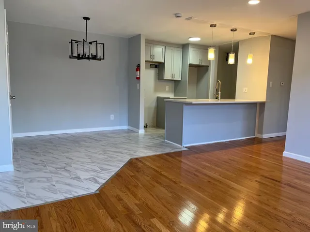 a view of kitchen and hall with wooden floor