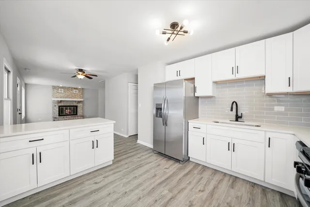 a kitchen with white cabinets and stainless steel appliances