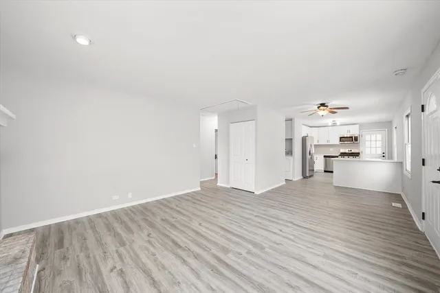 a view of a kitchen with wooden floor and a kitchen