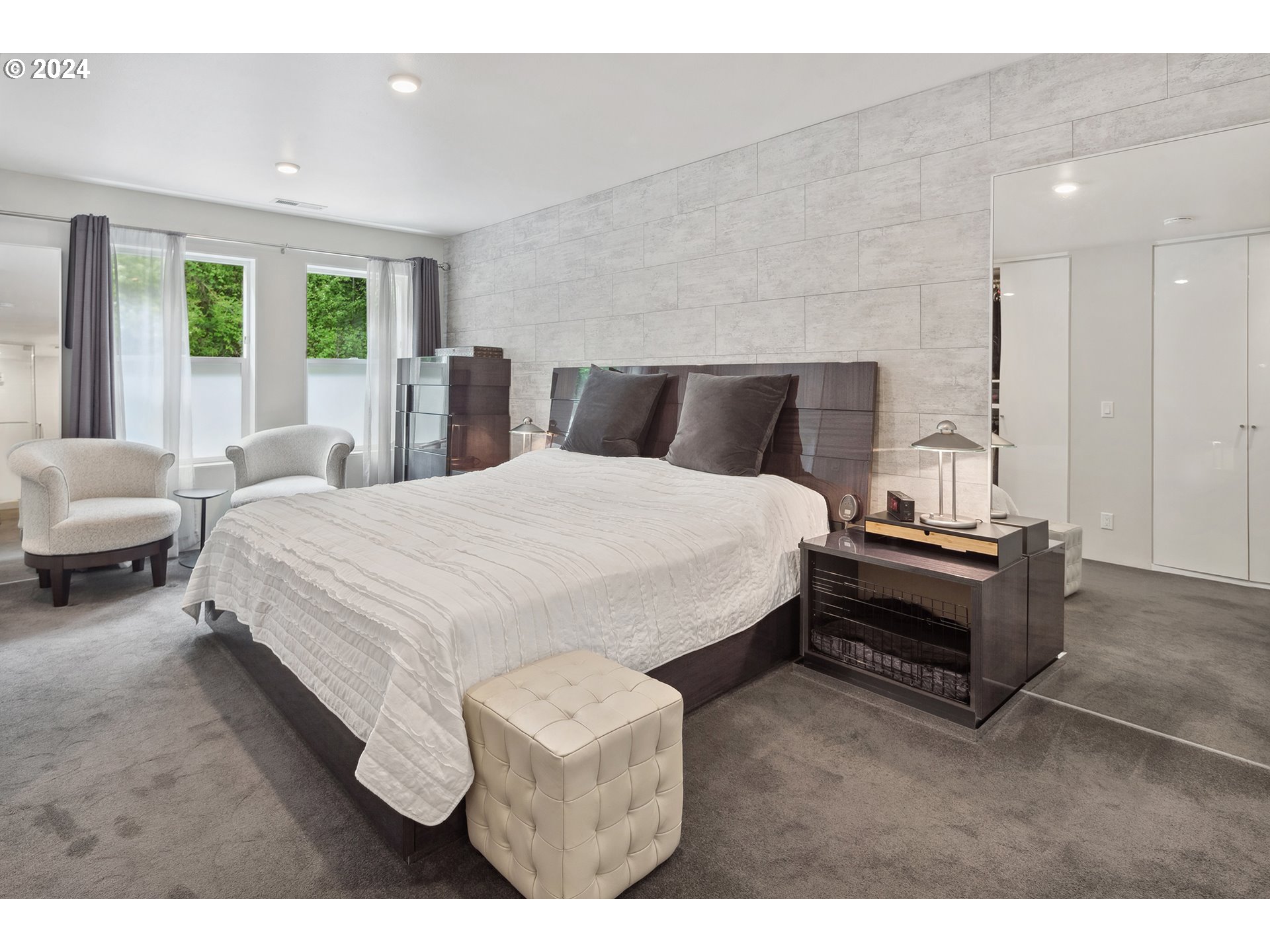 5427 Southwest View Point Terrace Portland, OR 97239 - Photo 18 of 40 a spacious bedroom with a bed and a couch