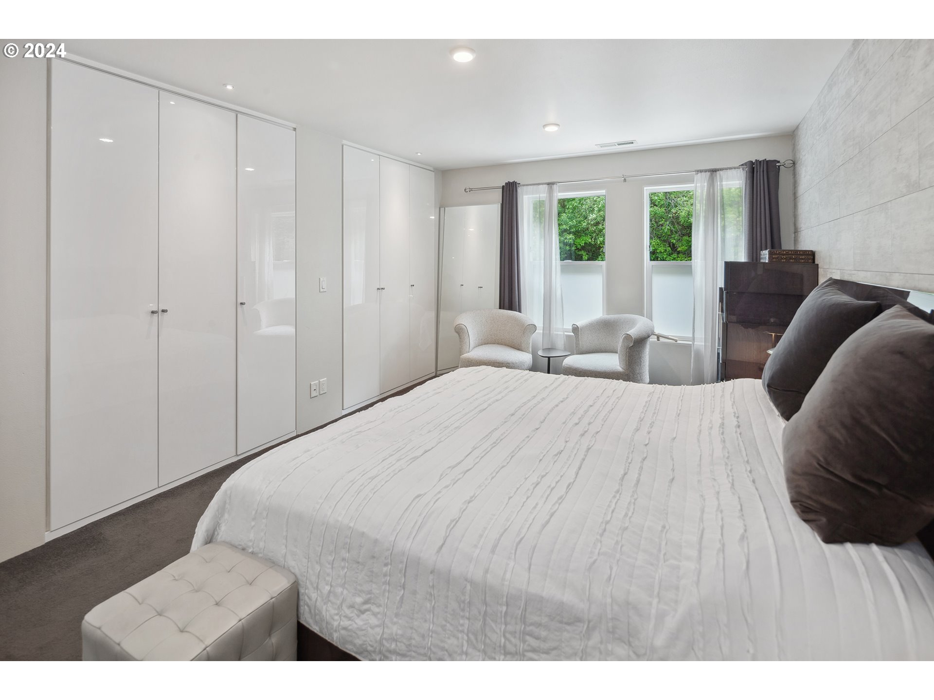 5427 Southwest View Point Terrace Portland, OR 97239 - Photo 19 of 40 a bedroom with a large bed and a large window