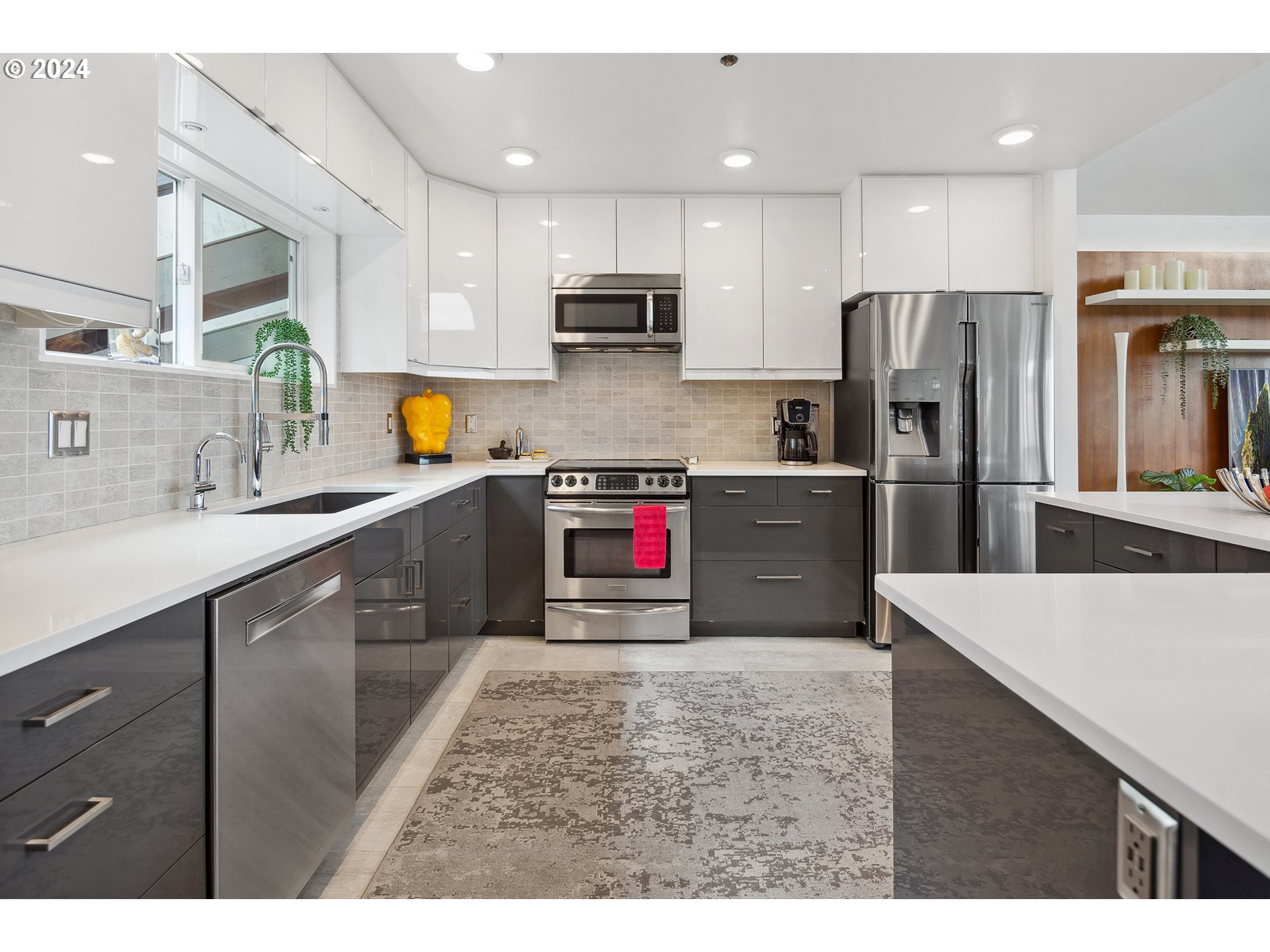 5427 Southwest View Point Terrace Portland, OR 97239 - Photo 7 of 40 a kitchen with stainless steel appliances a refrigerator sink and microwave