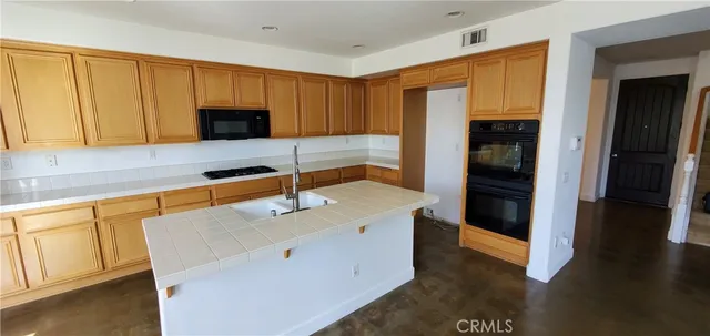 a kitchen with a sink a stove and refrigerator