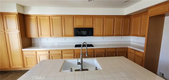 a kitchen with a sink and a refrigerator