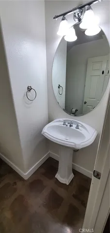 a bathroom with a sink a mirror and a toilet