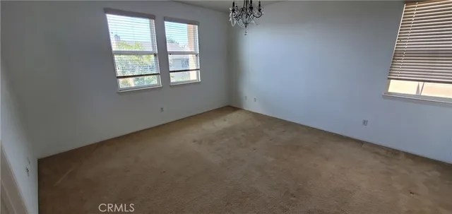 an empty room with windows and entrance