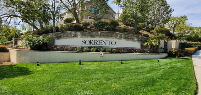 a view of pool with lawn chairs and plants