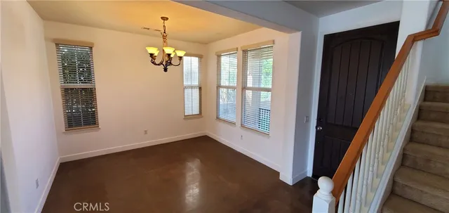 a view of a livingroom with wooden floor and windows