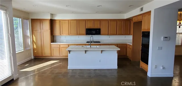 a kitchen with a sink cabinets and a window