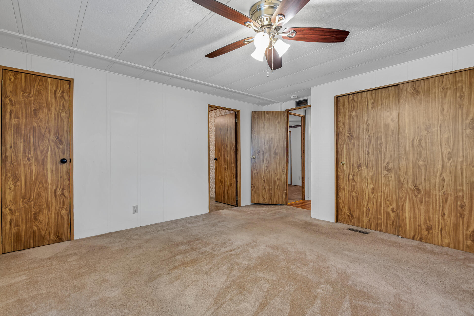 350 Gilmore Road, Unit SPC 88 Red Bluff, CA 96080 - Photo 14 of 31 an empty room with a chandelier fan and closet area