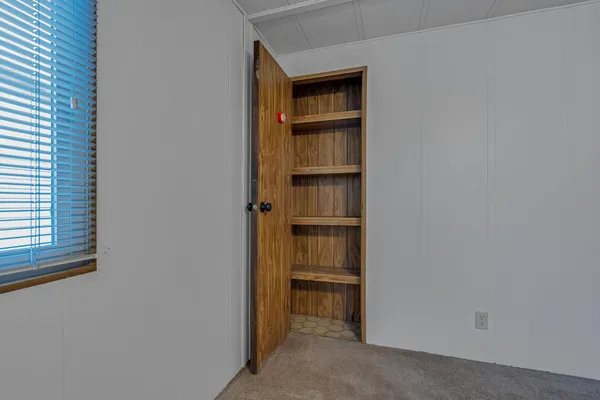 a view of walk in closet with empty racks