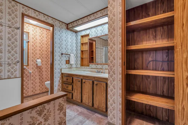 a bathroom with a sink a mirror and a toilet