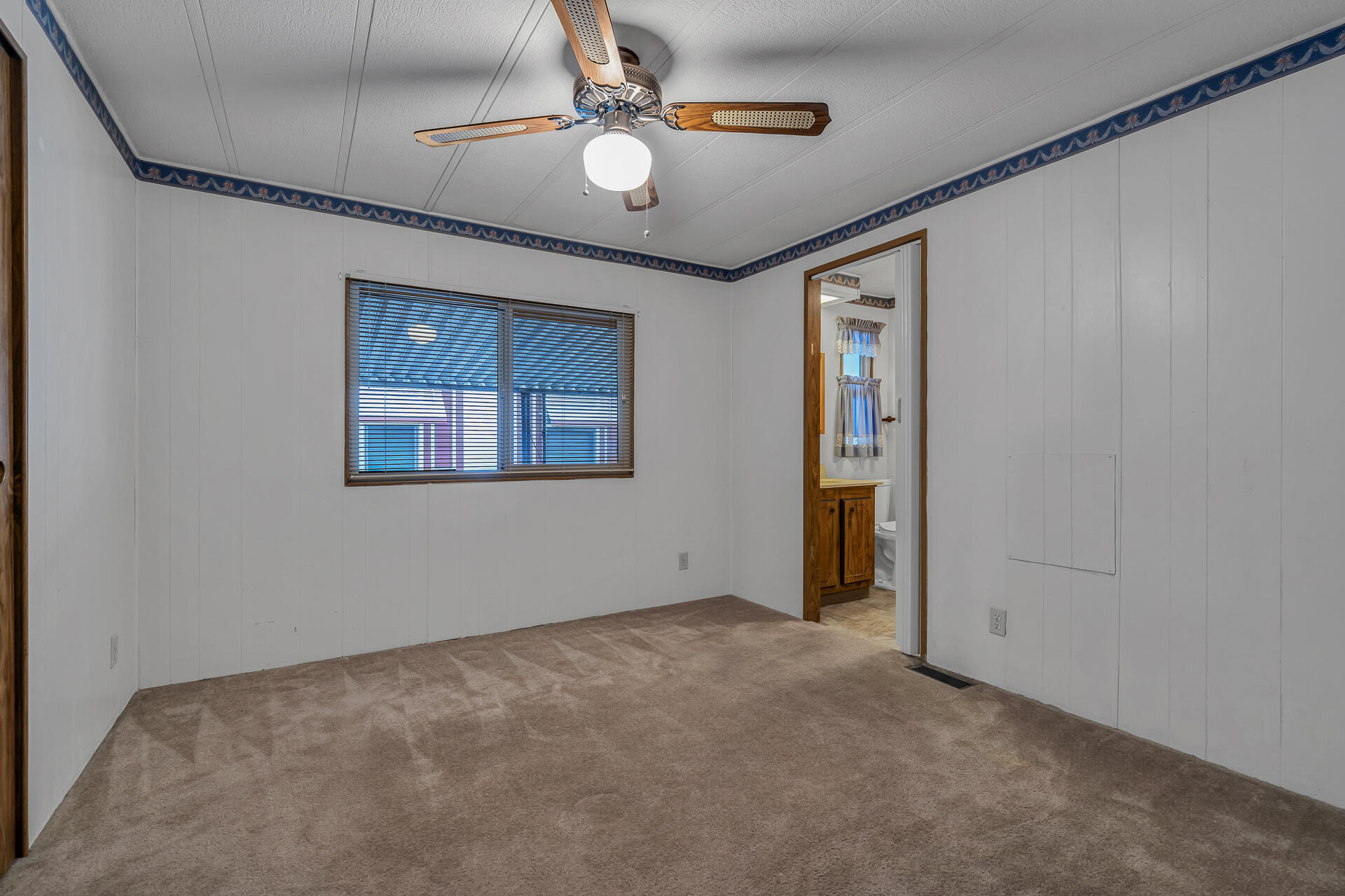 350 Gilmore Road, Unit SPC 88 Red Bluff, CA 96080 - Photo 19 of 31 an empty room with windows and fan