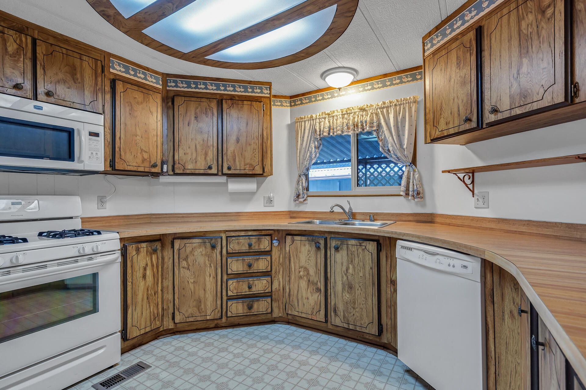 350 Gilmore Road, Unit SPC 88 Red Bluff, CA 96080 - Photo 31 of 31 a kitchen with a sink stove and cabinets