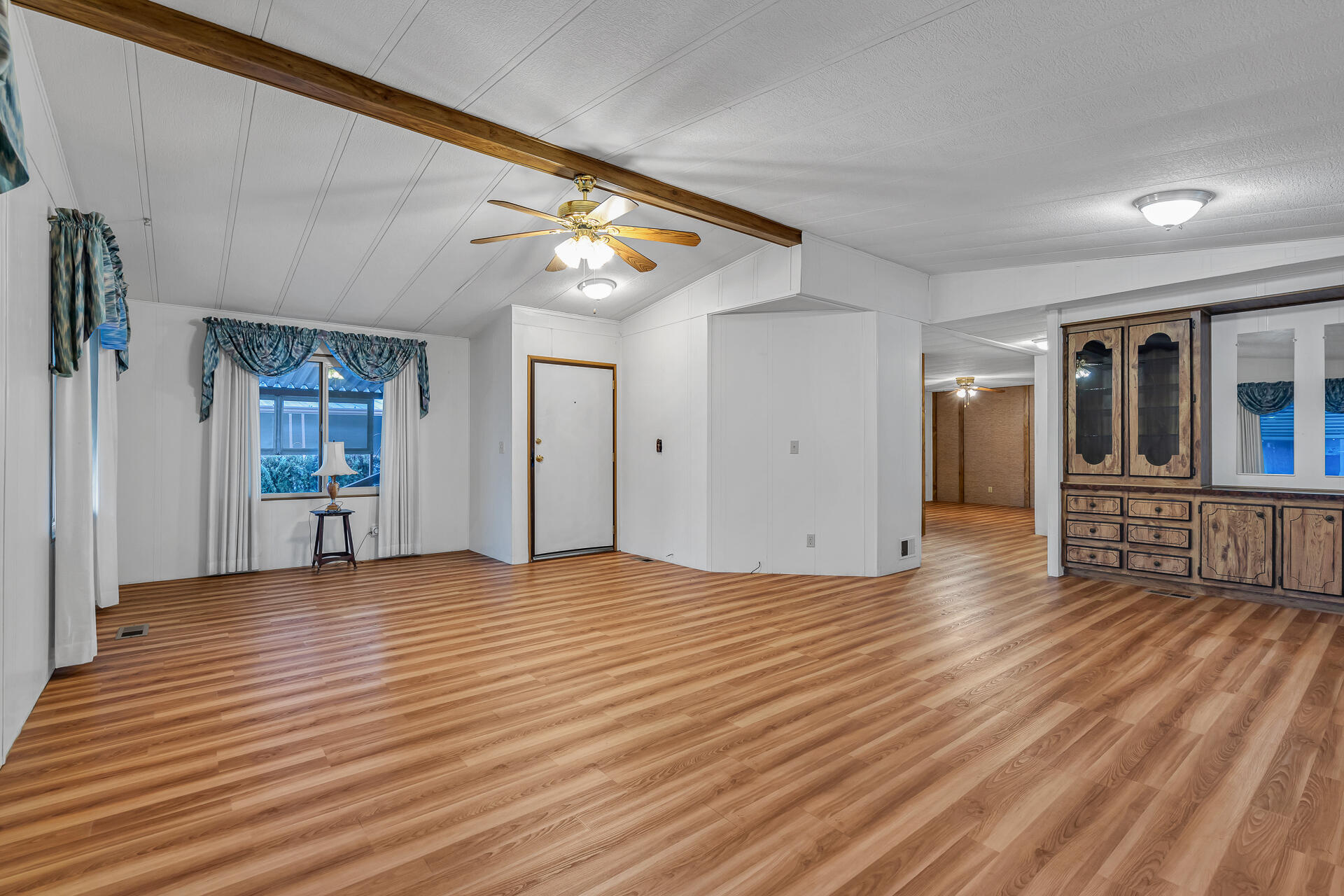 350 Gilmore Road, Unit SPC 88 Red Bluff, CA 96080 - Photo 4 of 31 a view of an empty room with wooden floor and a window