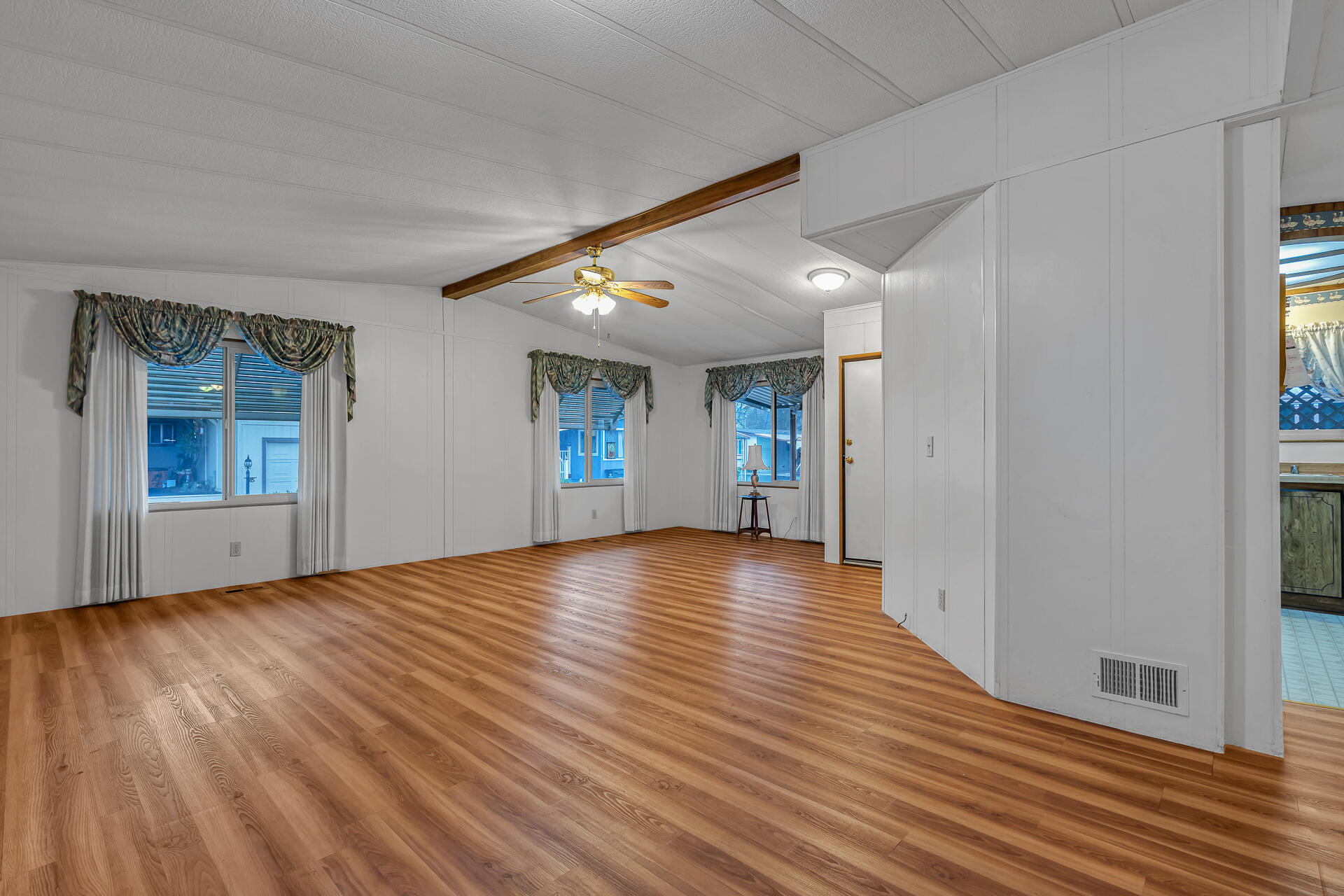 350 Gilmore Road, Unit SPC 88 Red Bluff, CA 96080 - Photo 5 of 31 an empty room with wooden floor and windows