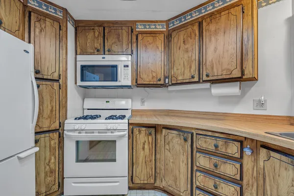 a kitchen with granite countertop cabinets stainless steel appliances and sink