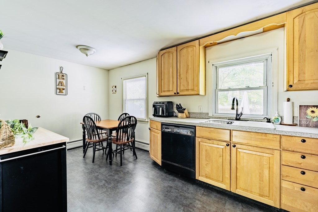52 Embassy Road Springfield, MA 01119 - Photo 11 of 27 a kitchen with granite countertop a sink cabinets and window