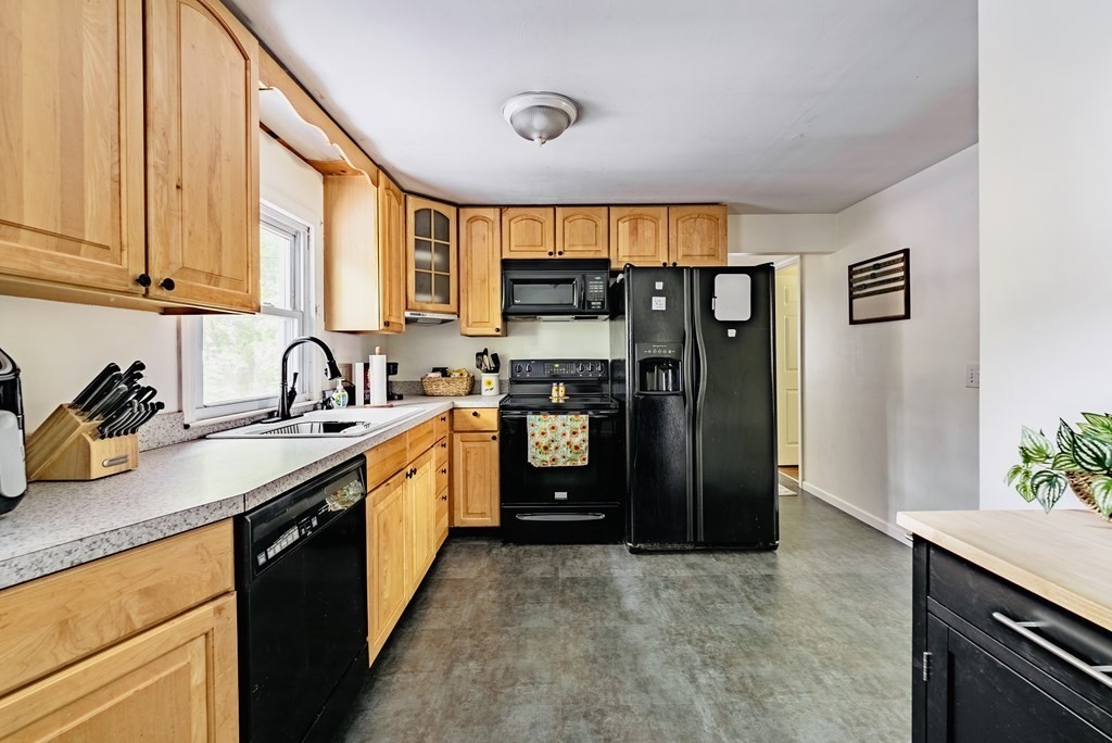 52 Embassy Road Springfield, MA 01119 - Photo 13 of 27 a kitchen with stainless steel appliances granite countertop a refrigerator and a sink