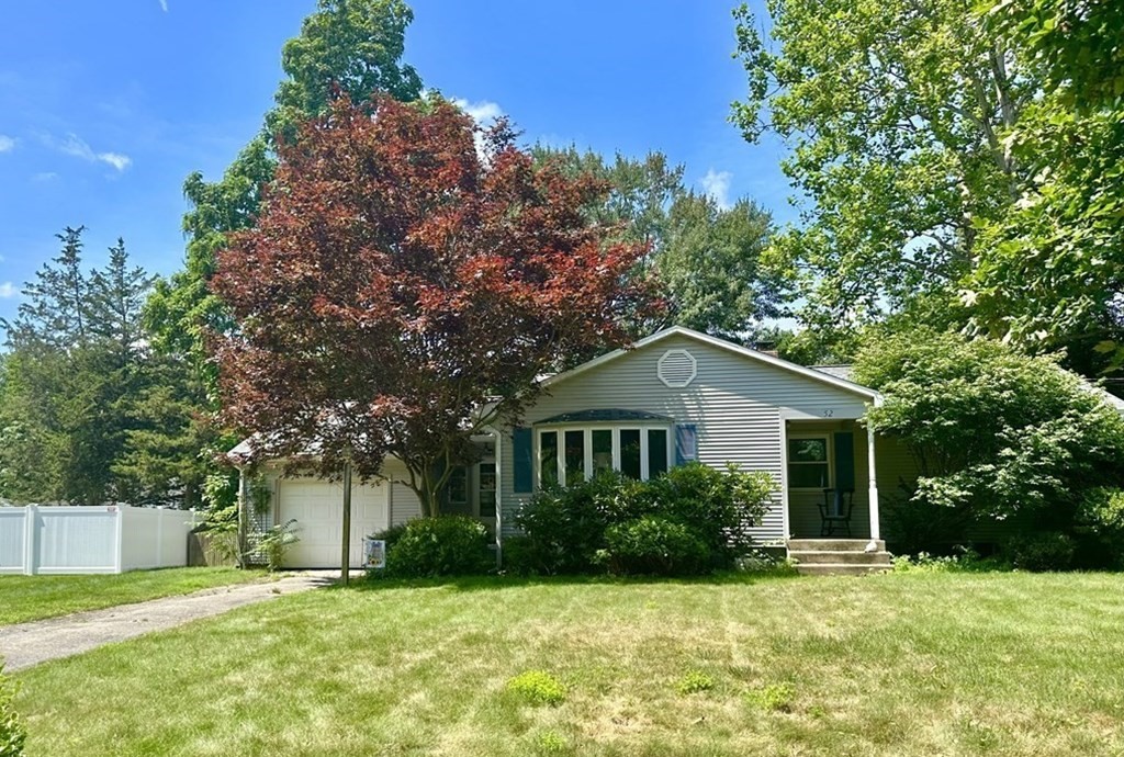 52 Embassy Road Springfield, MA 01119 - Photo 2 of 27 a front view of a house with a yard and trees