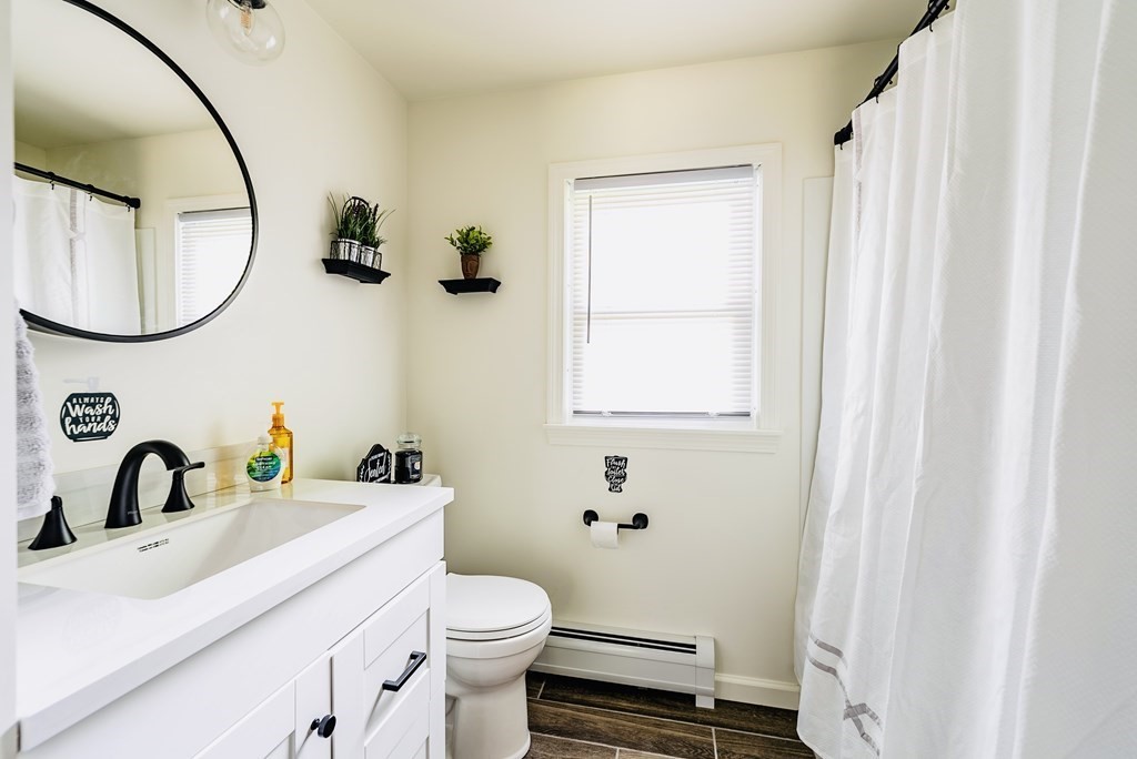 52 Embassy Road Springfield, MA 01119 - Photo 23 of 27 a bathroom with a sink toilet and a mirror