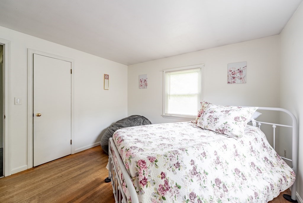 52 Embassy Road Springfield, MA 01119 - Photo 25 of 27 a bedroom with a bed and wooden floor