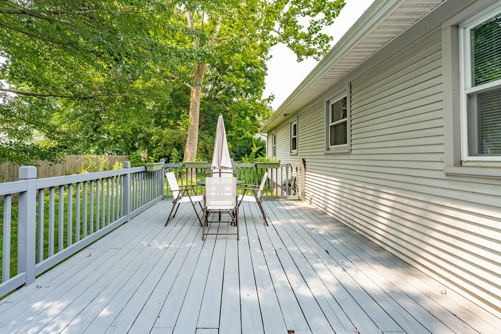 52 Embassy Road Springfield, MA 01119 - Photo 7 of 27 a view of deck with table and chairs and wooden floor