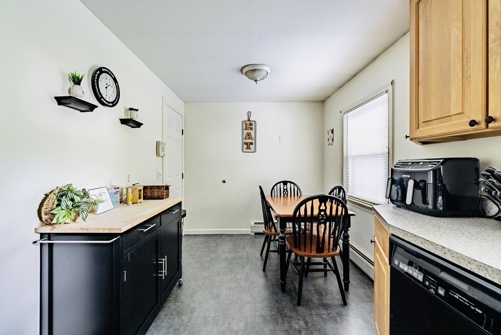 52 Embassy Road Springfield, MA 01119 - Photo 10 of 27 a kitchen with a table chairs and a refrigerator