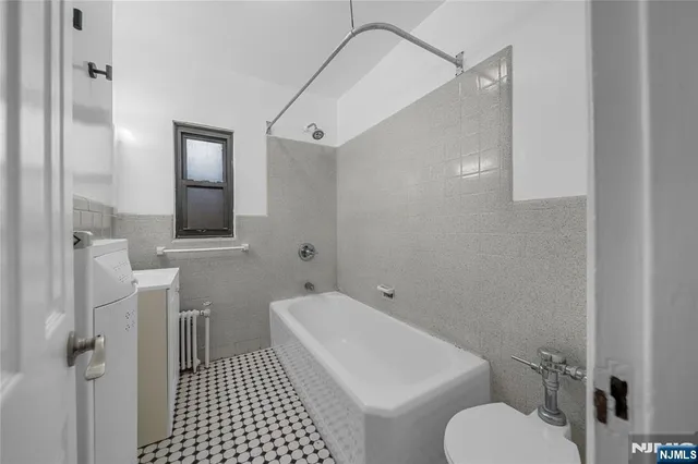 a bathroom with a toilet sink and shower