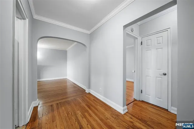 a view of hallway with wooden floor