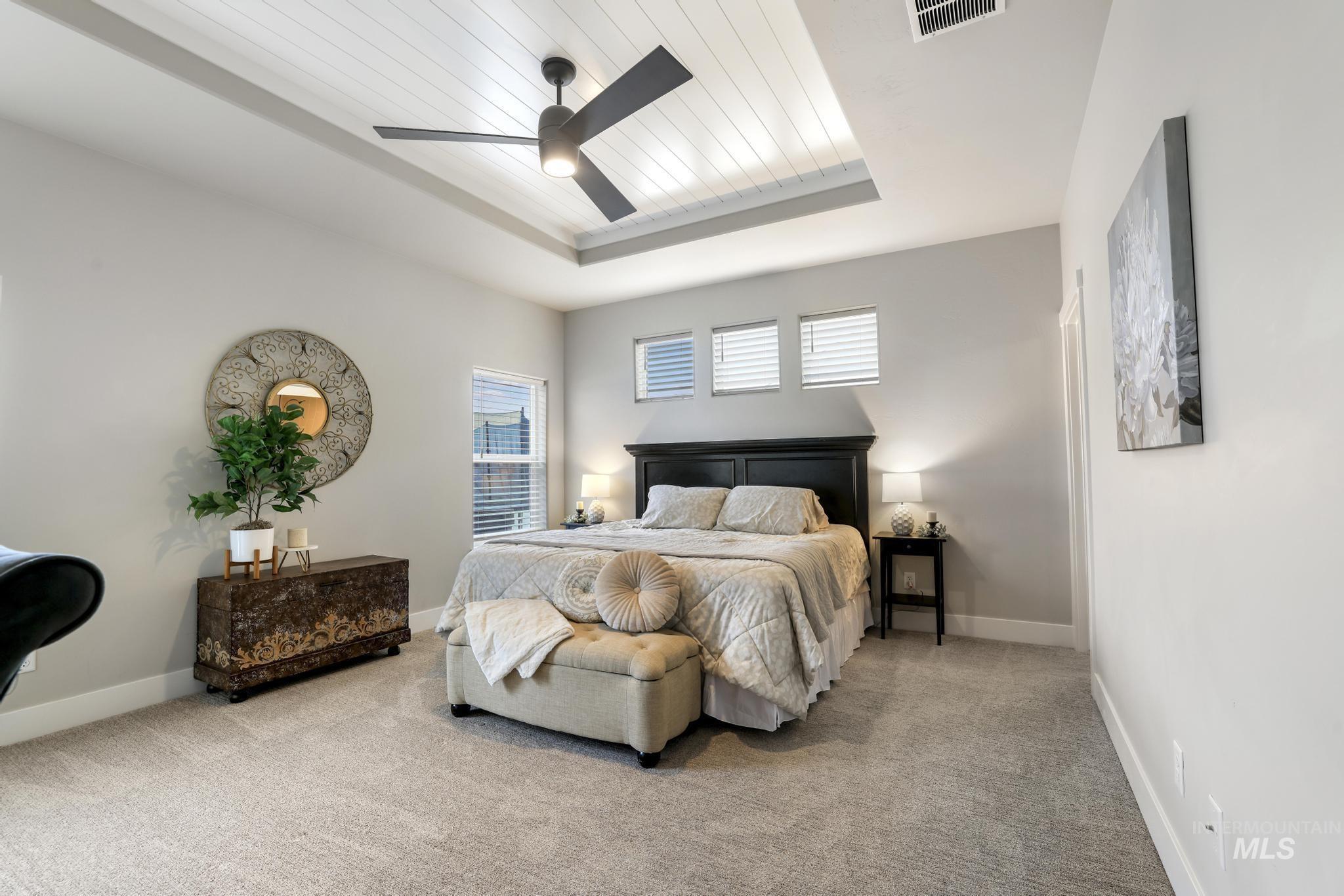 3103 Moonrise Road Twin Falls, ID 83301 - Photo 13 of 40 Bedroom featuring carpet, a wooden tray ceiling, and a ceiling fan
