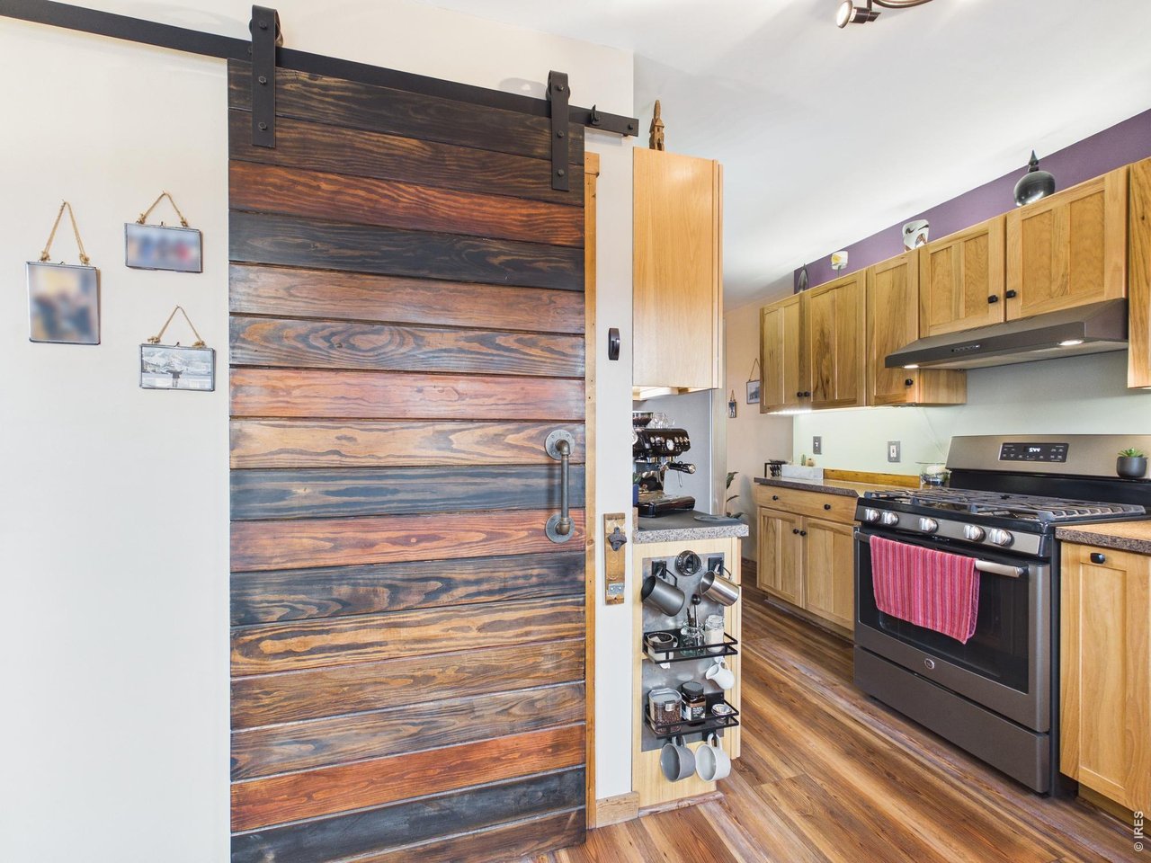 131 West Boulder Street Nederland, CO 80466 - Photo 14 of 46 Custom barn door and track, coffee center, rustic flooring, gas stove.