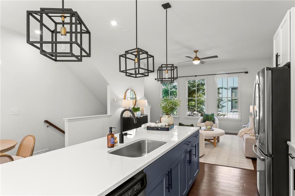 718 Needletail Way Atlanta, GA 30312 - Photo 11 of 44 a kitchen with sink a refrigerator and chairs