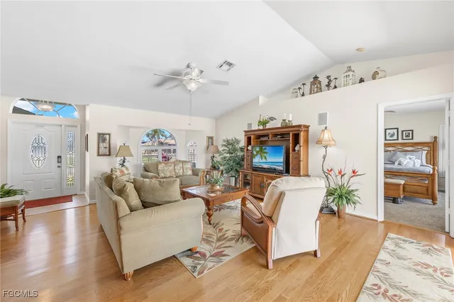 a living room with furniture fireplace and wooden floor