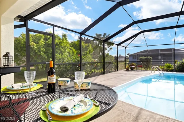 a living room with patio furniture and a large window
