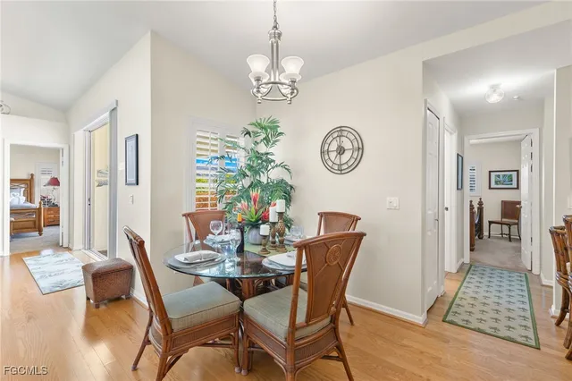 a view of a dining room with furniture and chandelier